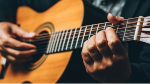 Close-up of a Man Playing Acoustic Guitar - Free Download