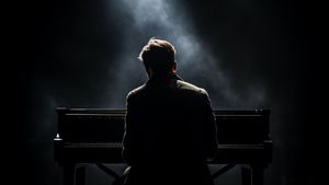 Silhouette of a man playing a piano in a dark smokey room - Free Download